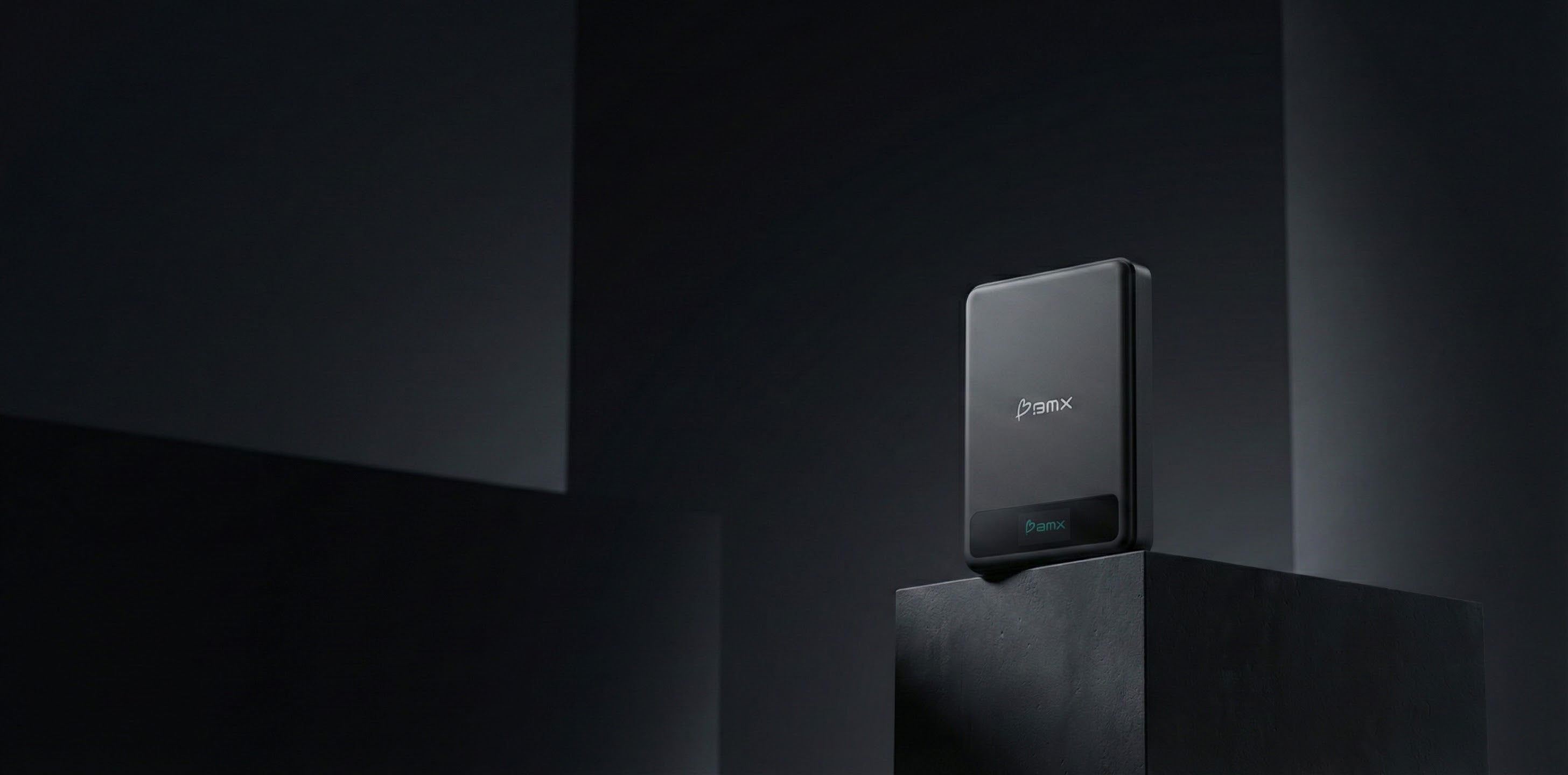Minimalist product shot of a BMX power bank on a dark pedestal.