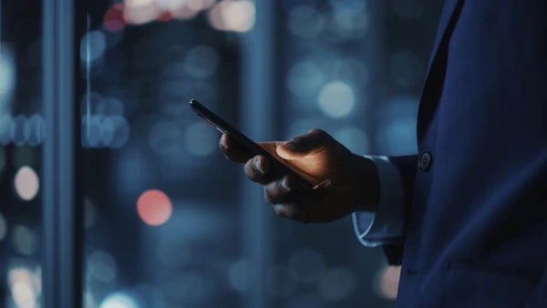 Professional using mobile technology, symbolizing SolidSafe™ solid-state power solutions for business partnersmage